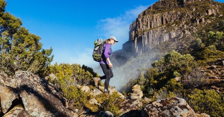 A woman hiking a mountain trail